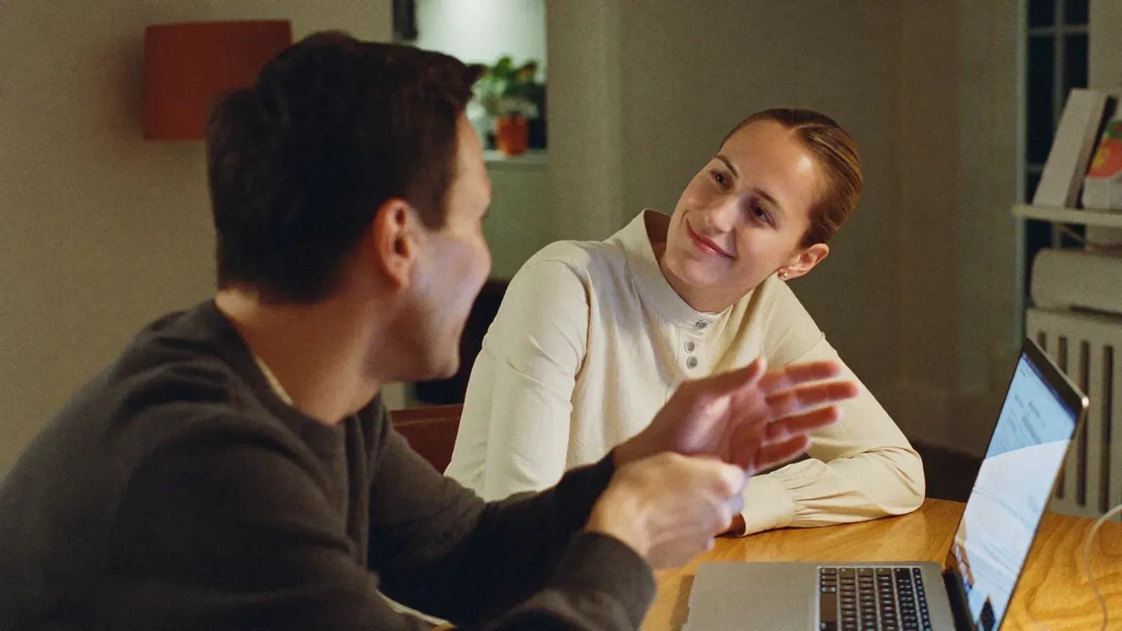 A married couple talking together at their dining table at home in Gilbert, Arizona during an online marriage coaching session