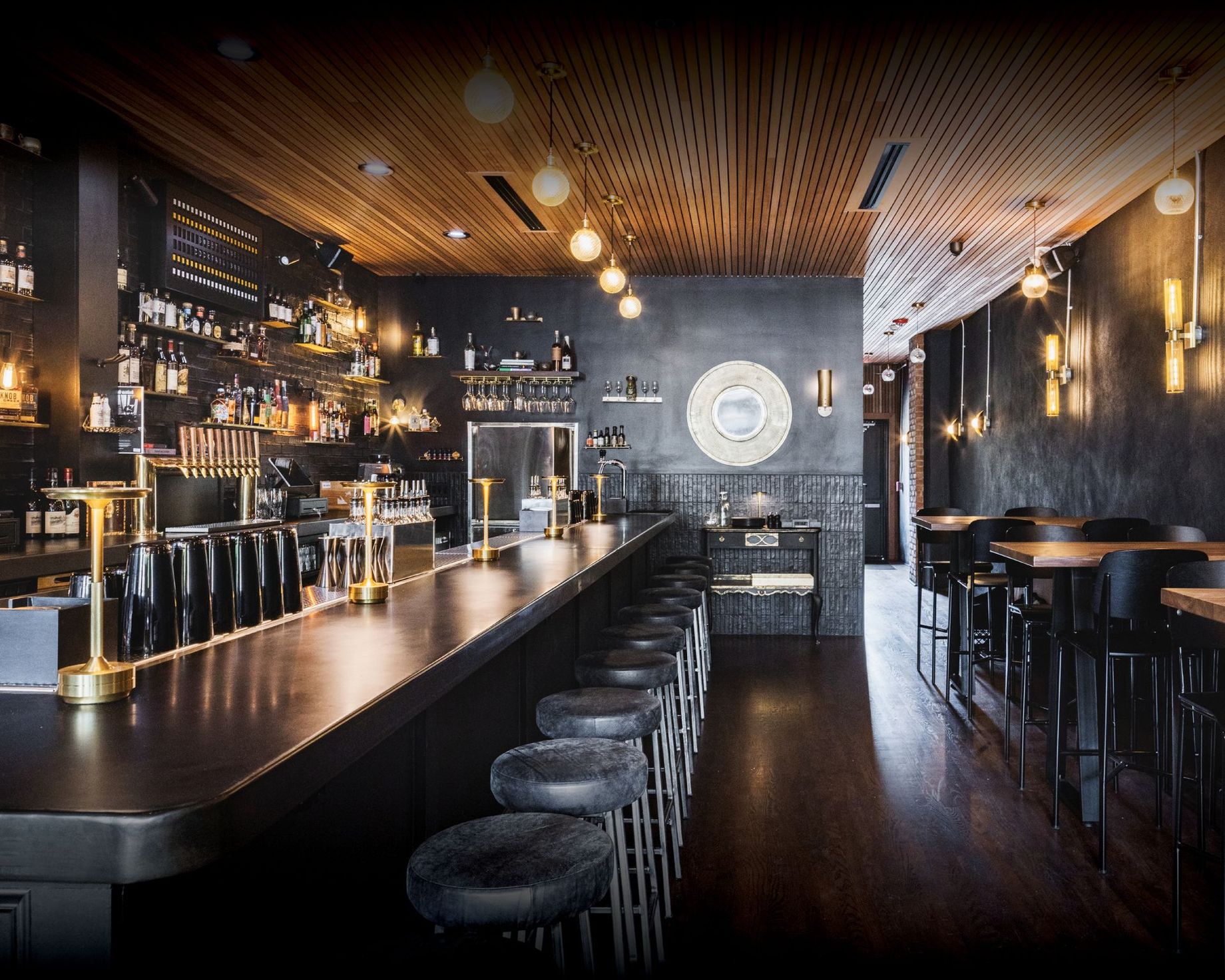 A restaurant with a long bar and stools