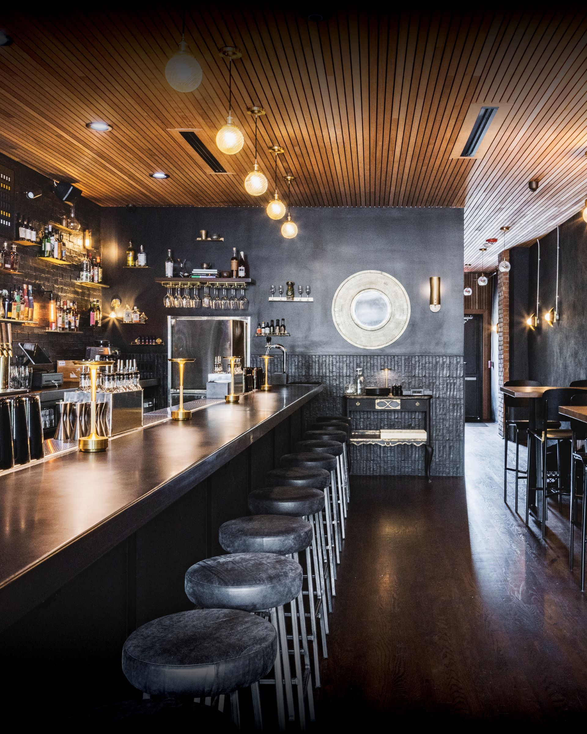 A restaurant with a long bar and stools