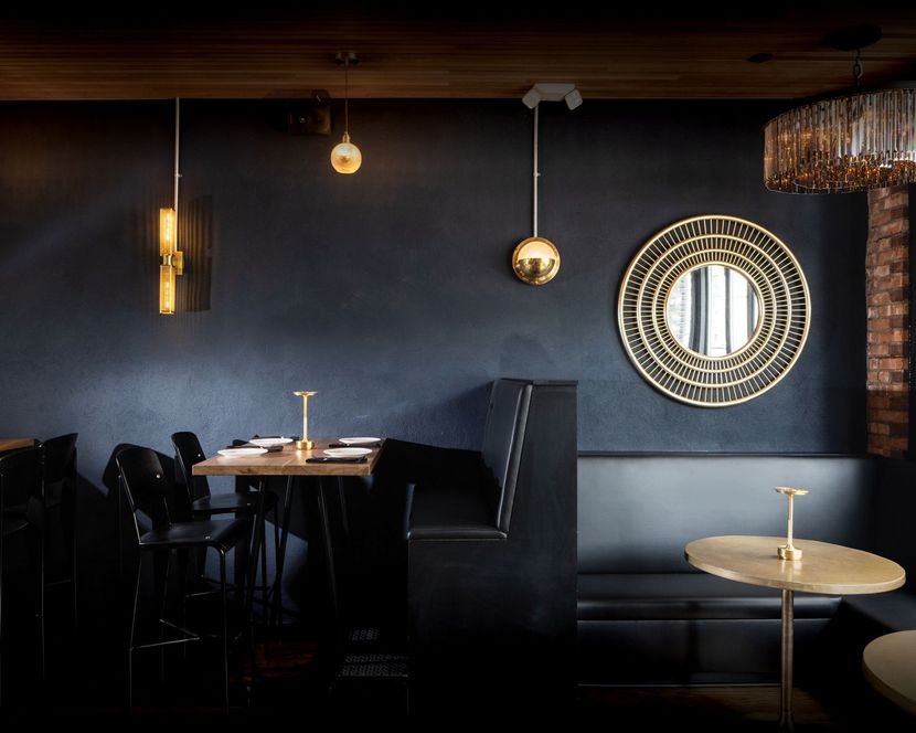 A restaurant with tables and chairs and a mirror on the wall