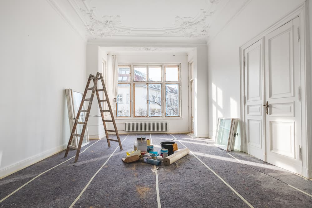An Empty Room with A Ladder and Paint Supplies — MJ Watson Construction and Maintenance in Wagga Wagga, NSW