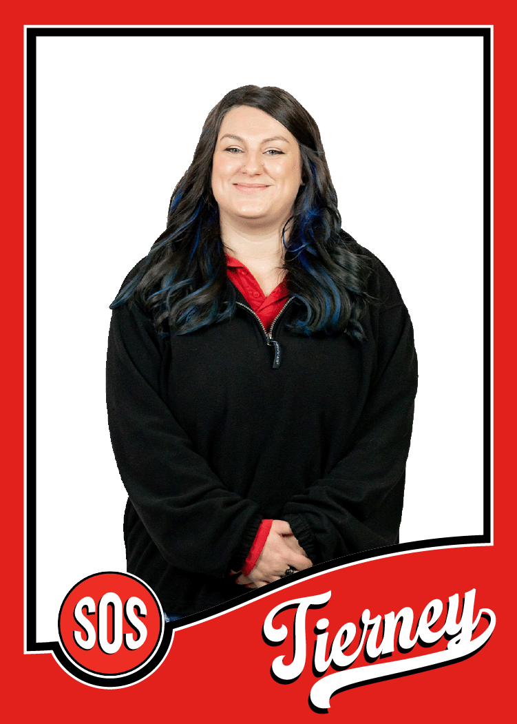Tierney is the Office Manager and is standing and smiling
