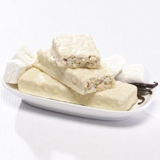 White frosted protein bars and marshmallows on a white plate, vanilla bean visible.