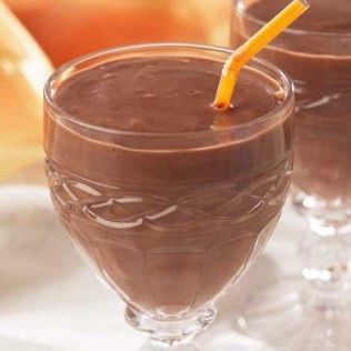 Chocolate smoothie in ornate glass with a yellow straw.