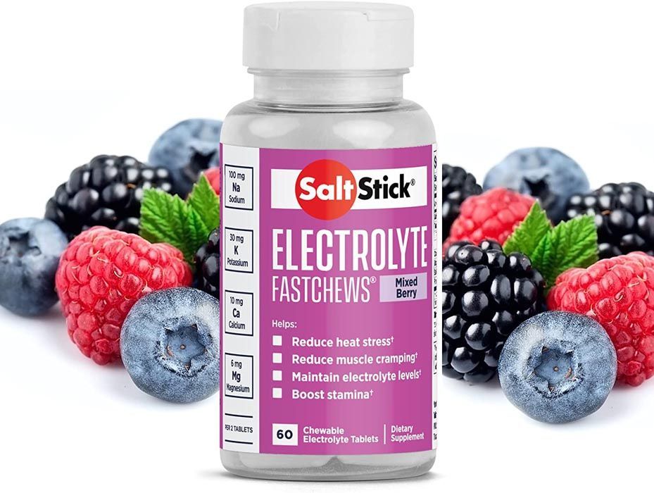Bottle of SaltStick electrolyte chews with berries in background.