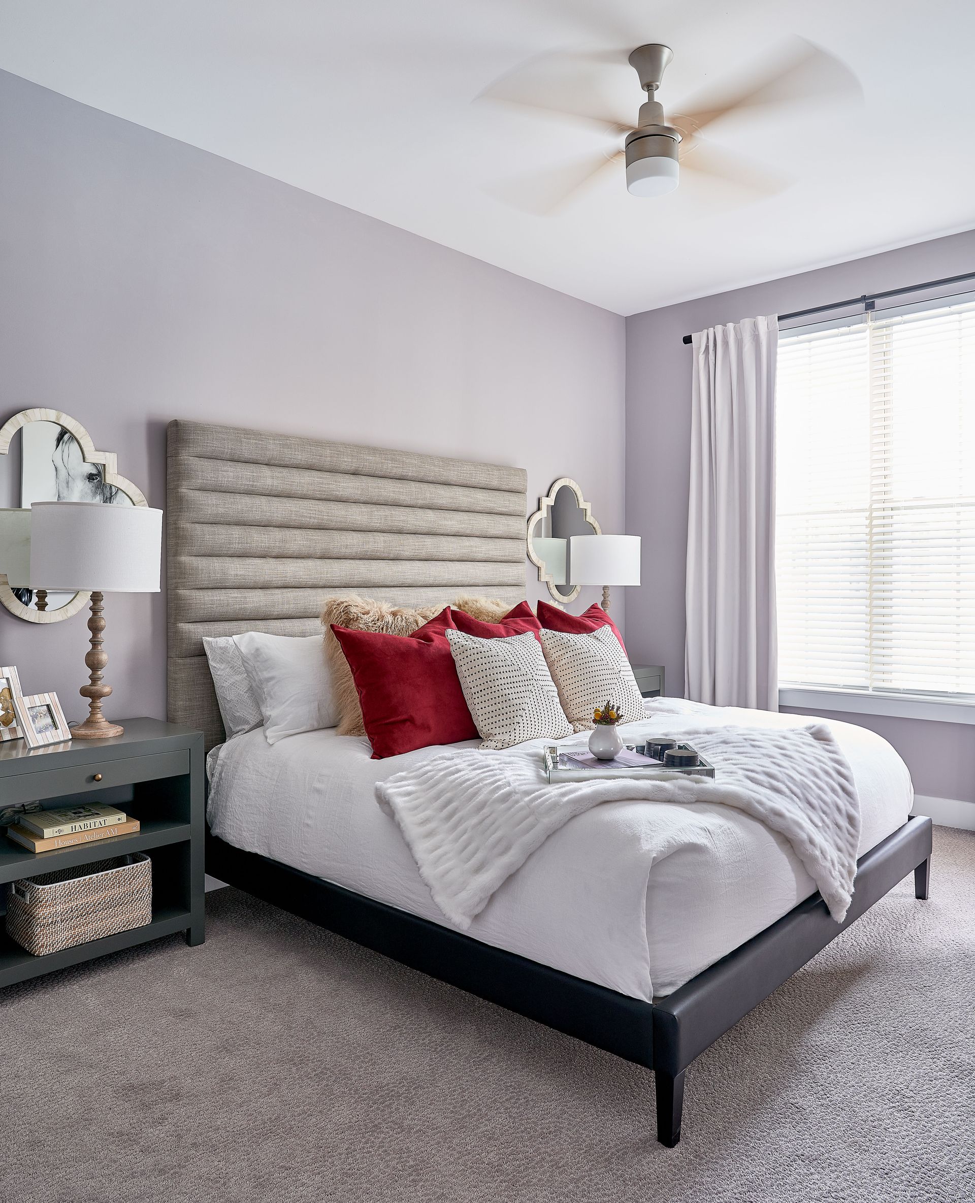 Bedroom with lavender walls, upholstered headboard, and gray carpet.