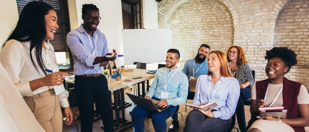 Leadership training workshop with a diverse team in a modern office