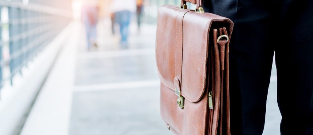 Employee carrying a briefcase while walking to work.