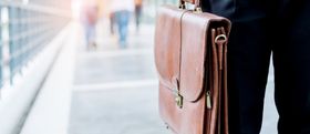 Employee carrying a briefcase while walking to work.