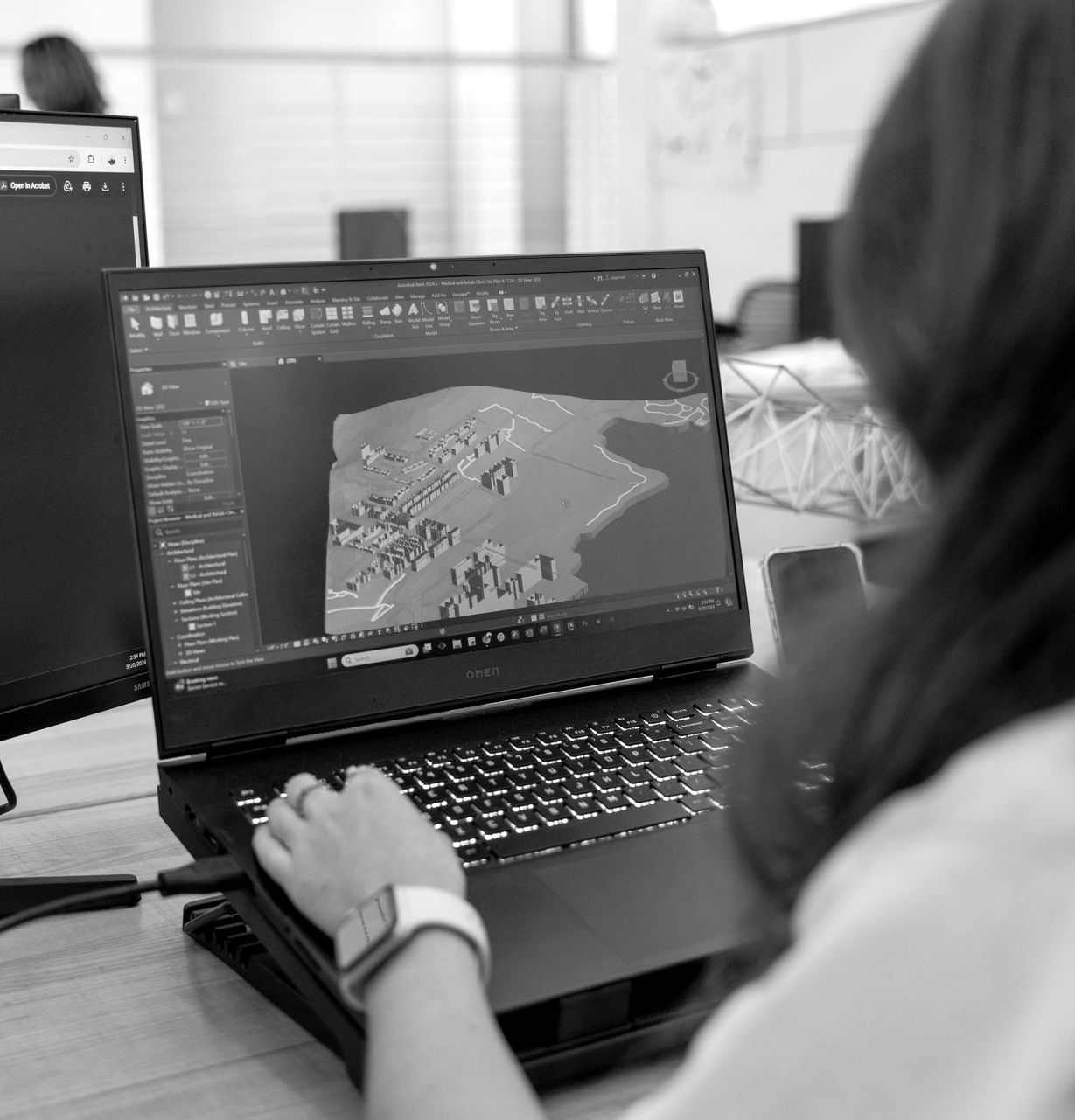 A woman working on an urban development 3d model on a laptop
