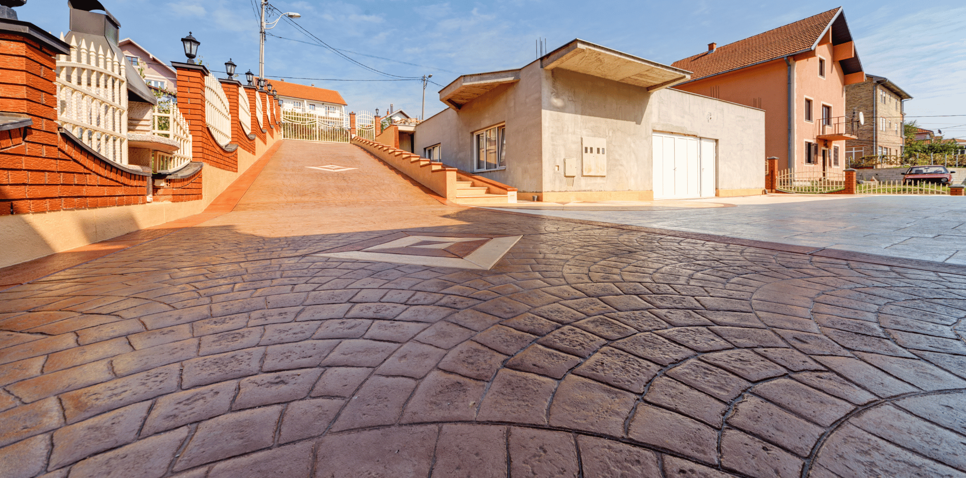 A cobblestone street with a brick building in the background