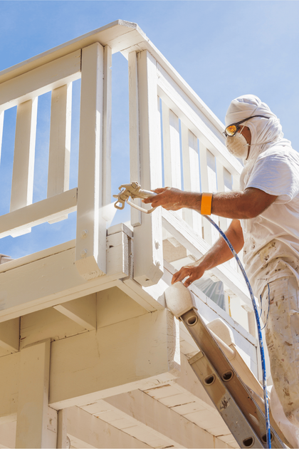 A professional painter painting a deck