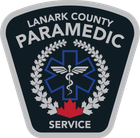 Lanark County Paramedic Service logo: black and silver shield with text, blue Star of Life, red maple leaf.