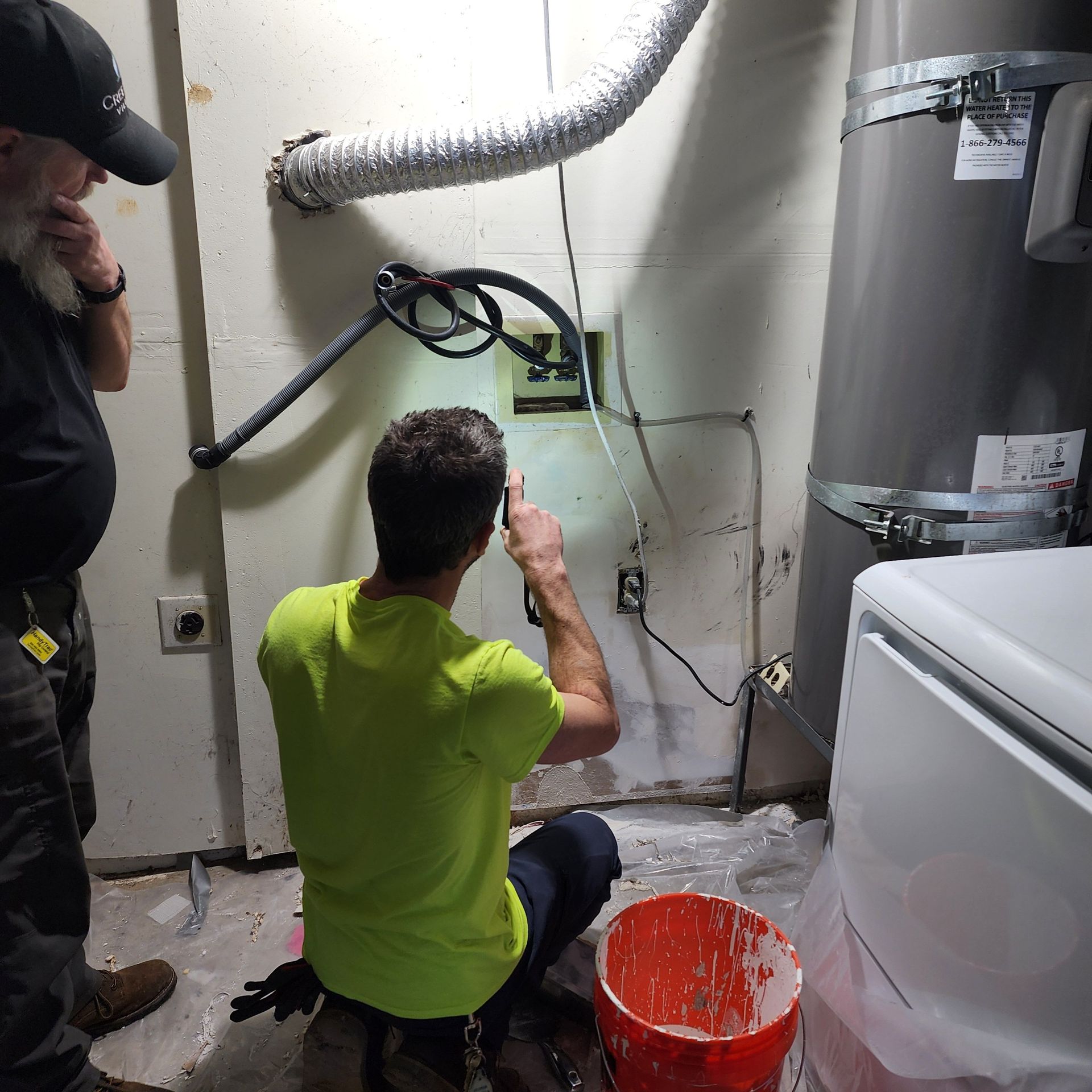Maxwell Plumbing journeyman plumber evaluating a leak in a washer box in Vancouver, WA.