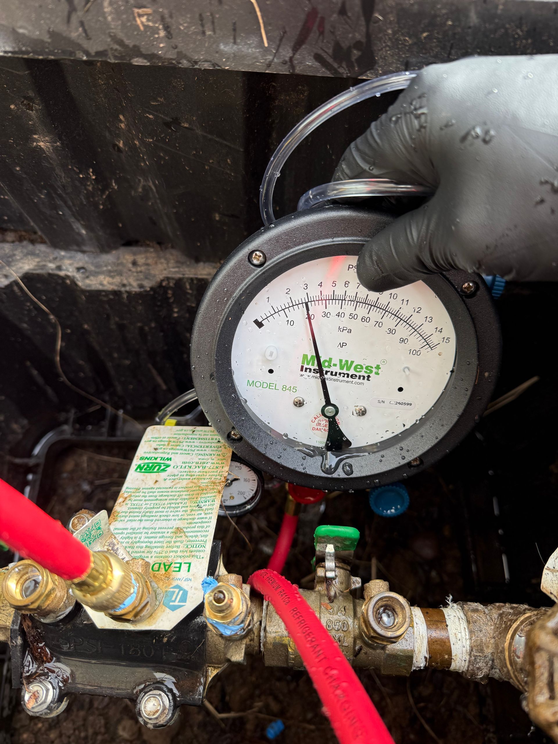 Image of Backflow guage being used to test 