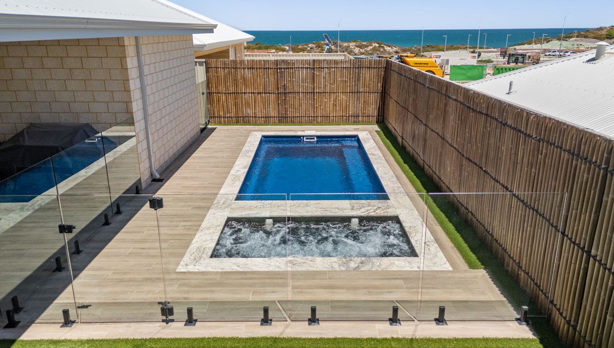 A Swimming in a Pool With a Spa pool looking out to sand dunes — SJ Pools and Concreting in Dubbo, NSW
