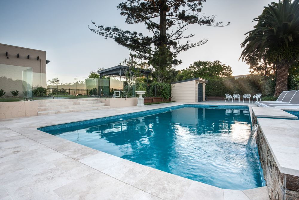 A Large Swimming Pool With Palm Trees in the Background
— SJ Pools and Concreting in Forbes, NSW