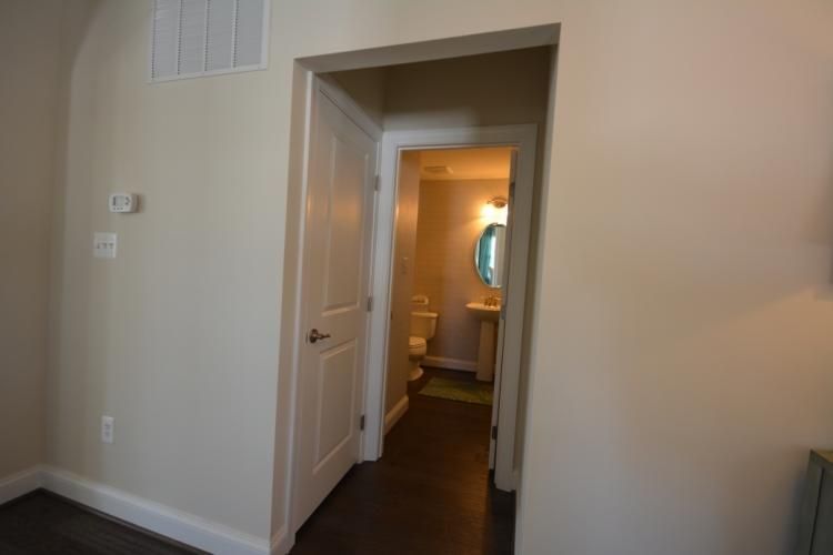 Doorway leading into a small bathroom with a toilet and sink.
