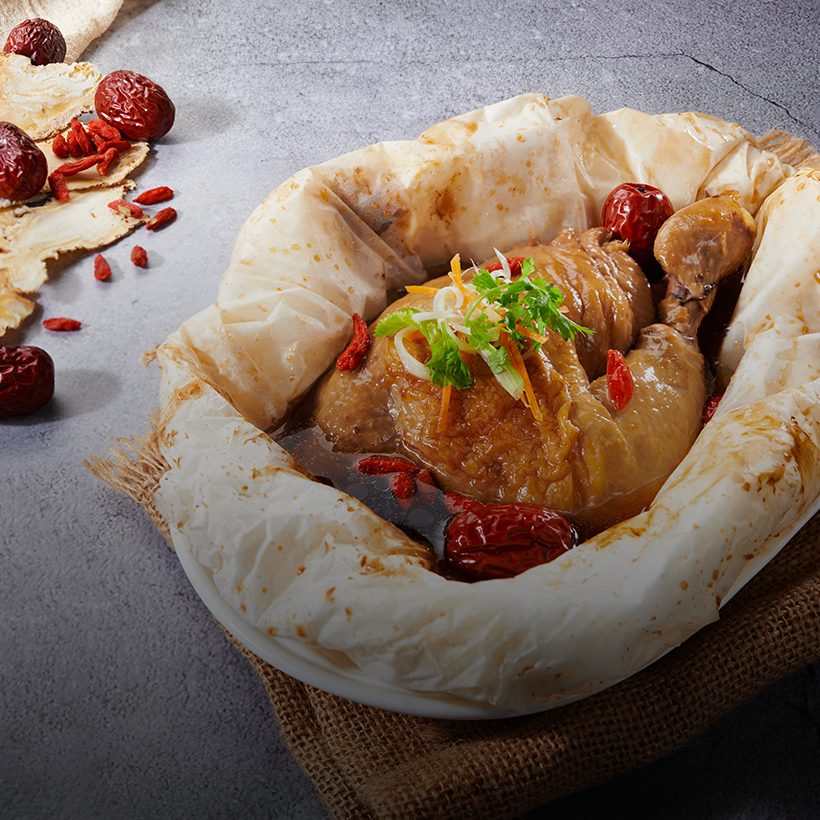 Baked herbal chicken, golden-brown and aromatic, served with fragrant herbs and spices, ready to be enjoyed