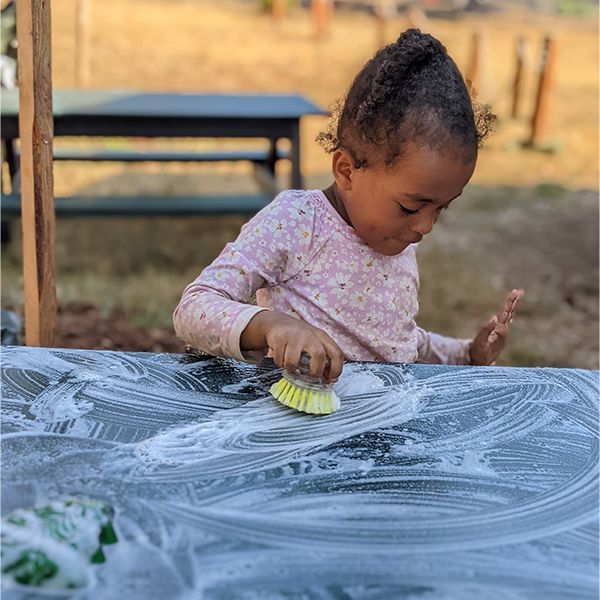 montessori child working with practical life skills
