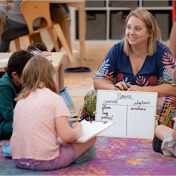 montessori guide and children working on language skills
