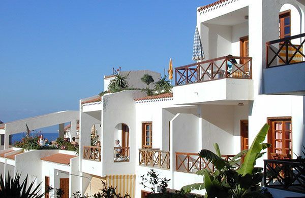 Ein weißes Gebäude mit einem Balkon mit Blick auf das Meer