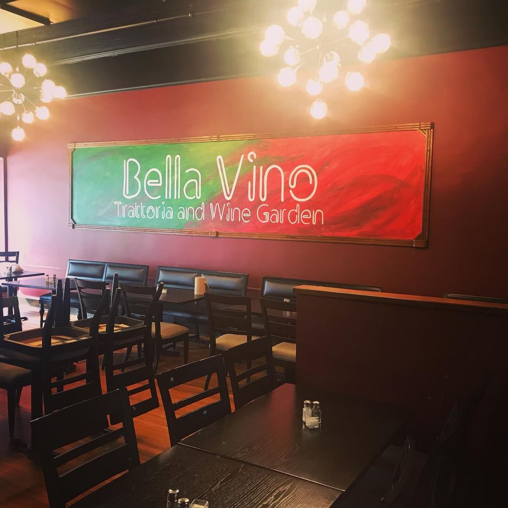 Interior of Bella Vino Italian restaurant and wine garden with red walls and empty tables