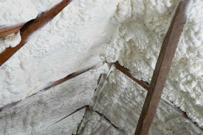 Worker Installing Fiberglass Batt — Jacksonville, FL — North Florida Insulation