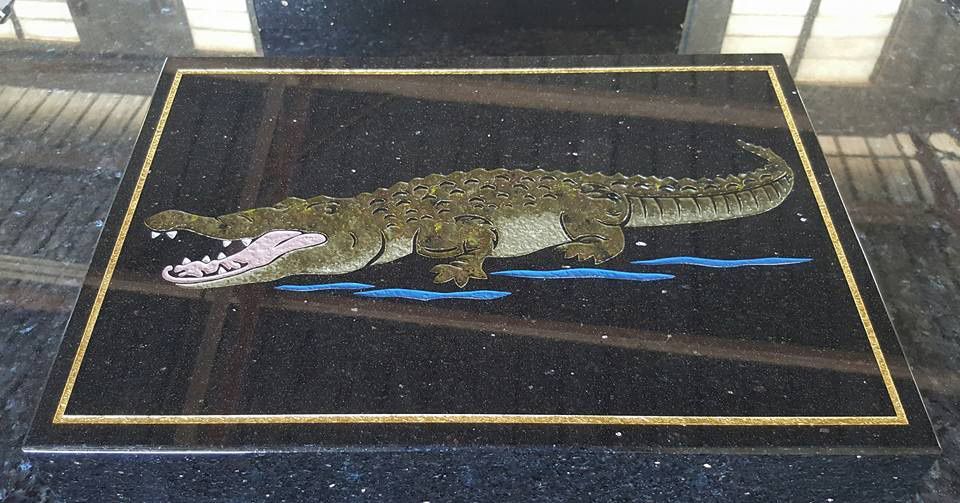 Mosaic of an Alligator on a Black Granite Surface, With a Gold Border โ Gori Marble & Granite Pty Ltd in Earlville, QLD