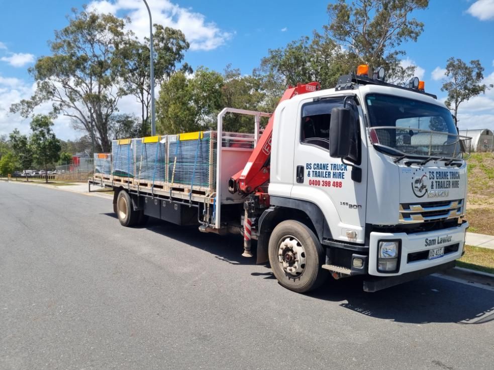 A White Truck With a Red Crane on the Back is Parked on the Side of the Road — BS Crane Truck and Trailer Hire In Buderim, QLD