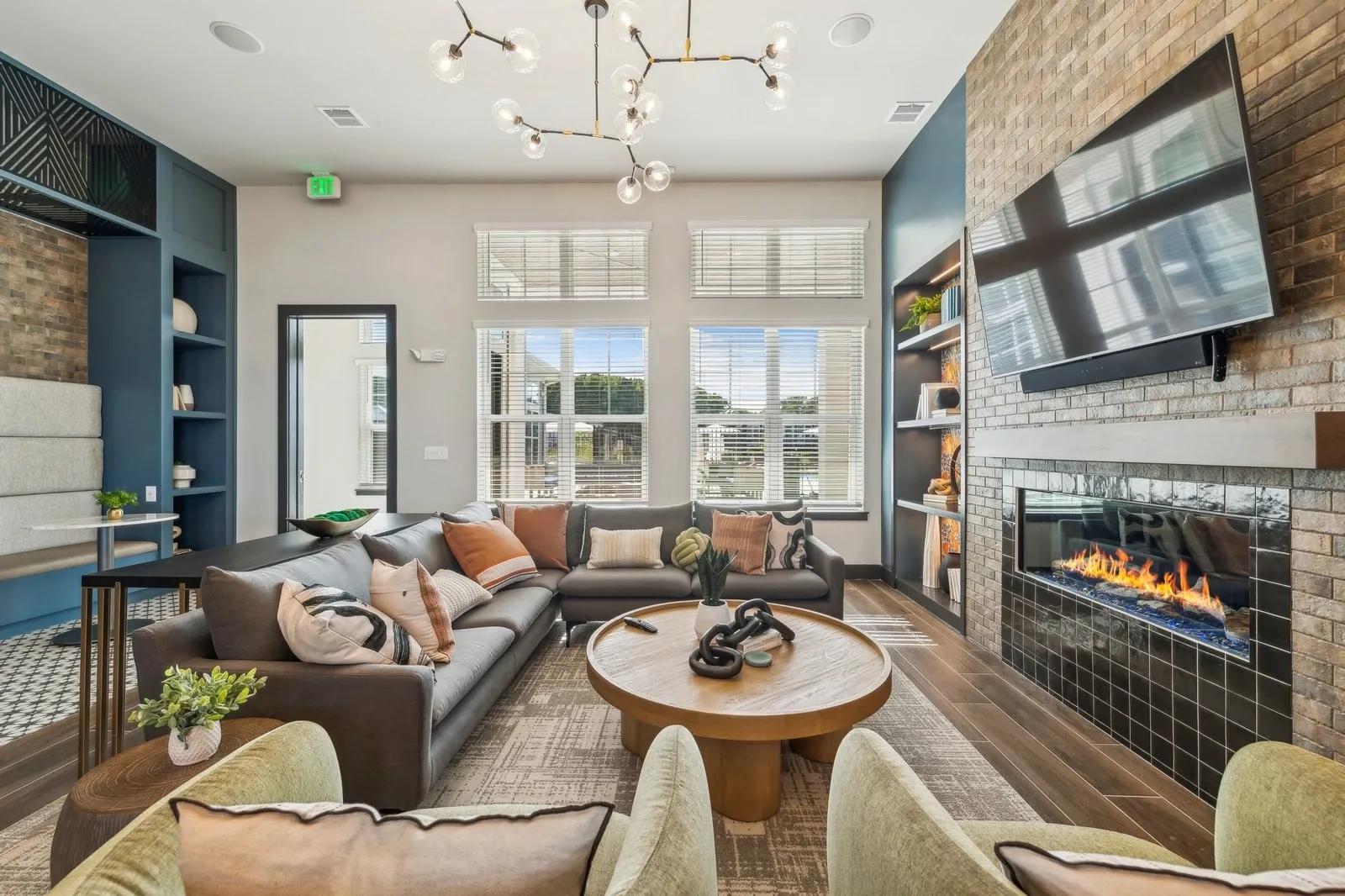 Interior resident lounge with sofa seating, fireplace, and TV.