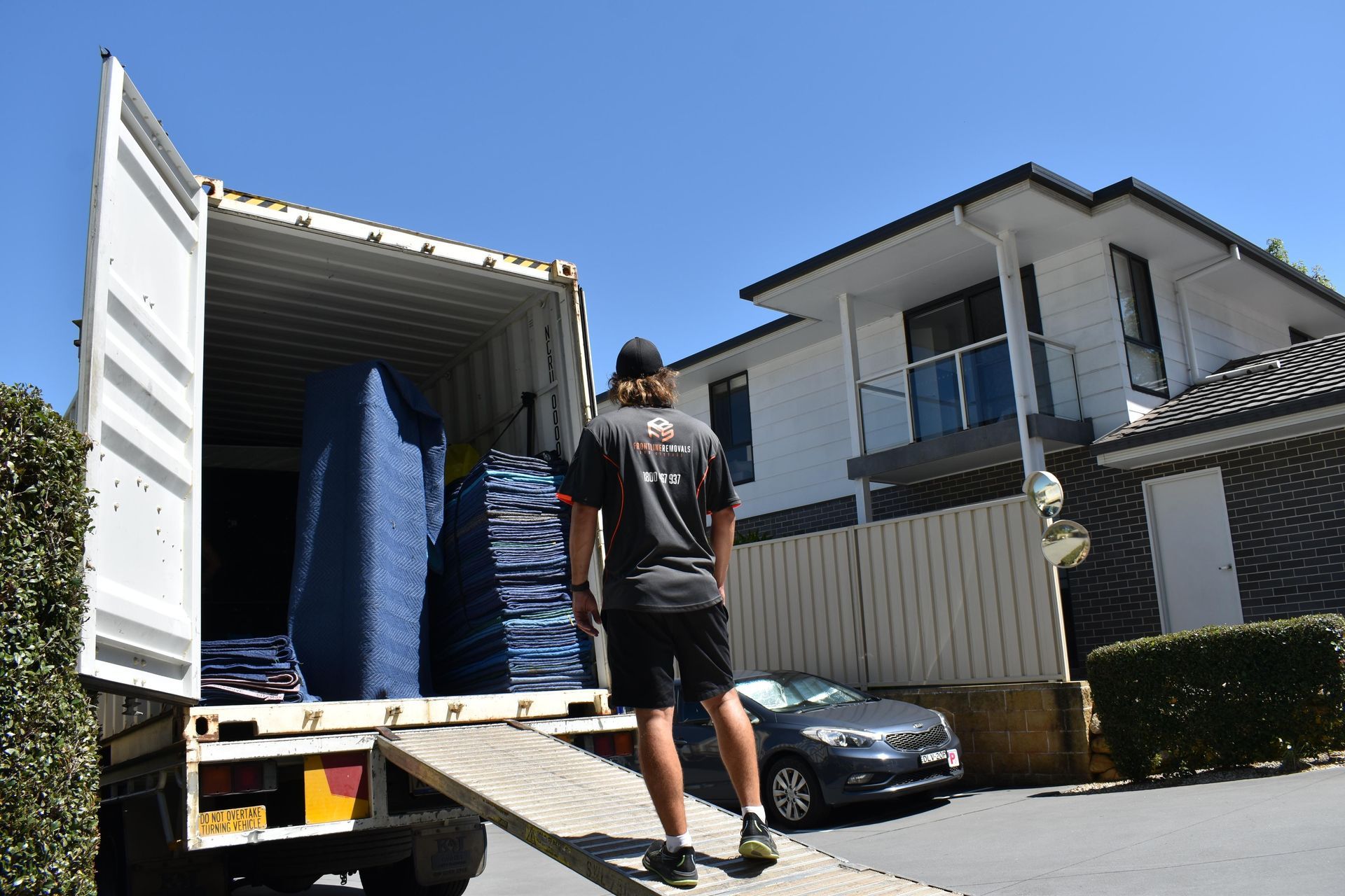 Man Loads Truck With Furniture — Frontline Removals And Storage in Port Macquarie, NSW