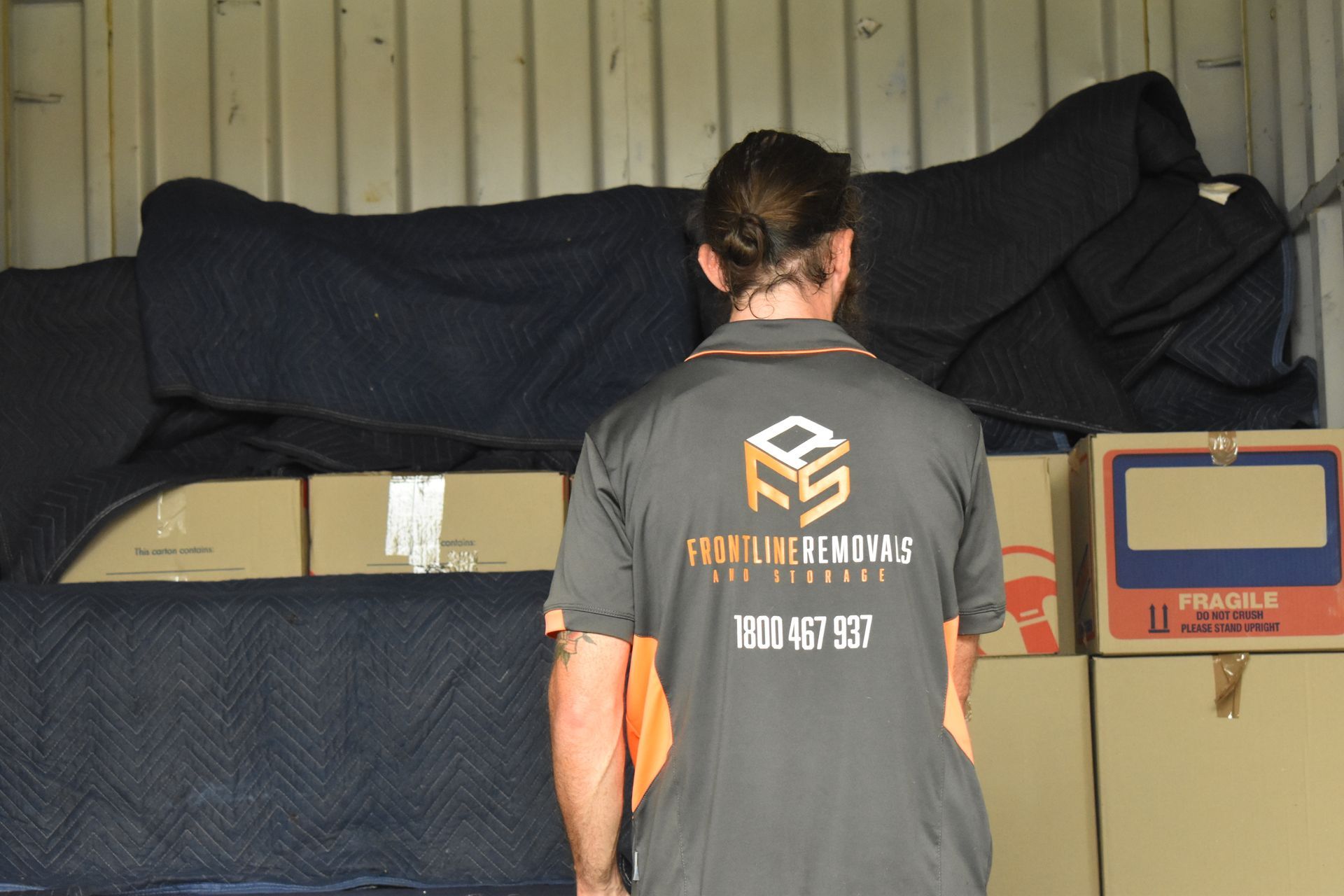 A Woman Writes On A Moving Box Using A Marker — Frontline Removals And Storage in Port Macquarie, NSW