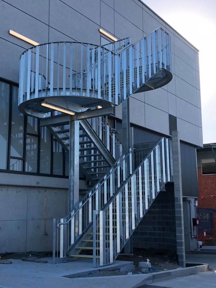 A Steel External Staircase at the Back of a Concrete Building — Burke Metal Fabrication In Taree, NSW