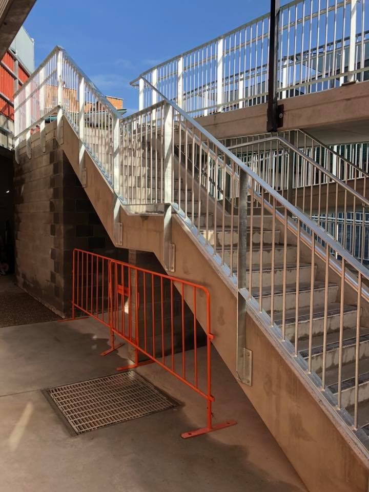 A Set of Stairs With a Metal Railing and an Orange Barrier — Burke Metal Fabrication In Taree, NSW