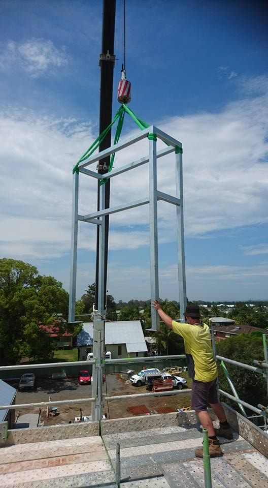 A Man Wearing a Welding Mask is Welding a Piece of Metal — Burke Metal Fabrication In Taree, NSW