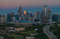 Aerial view of the Charlotte, North Carolina skyline at dusk, featuring Bank of America Stadium in the foreground.