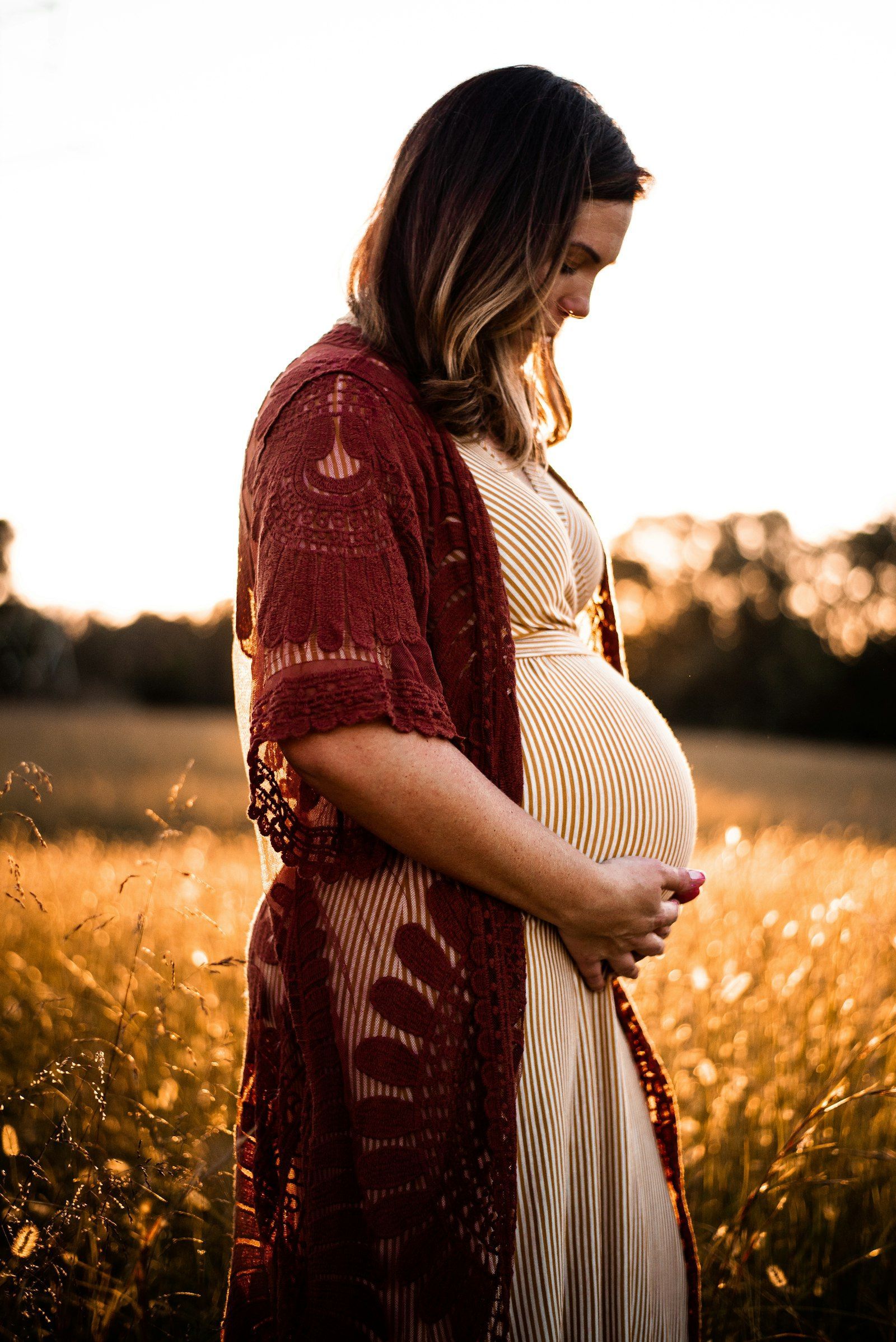 Pregnant woman in a sunny field