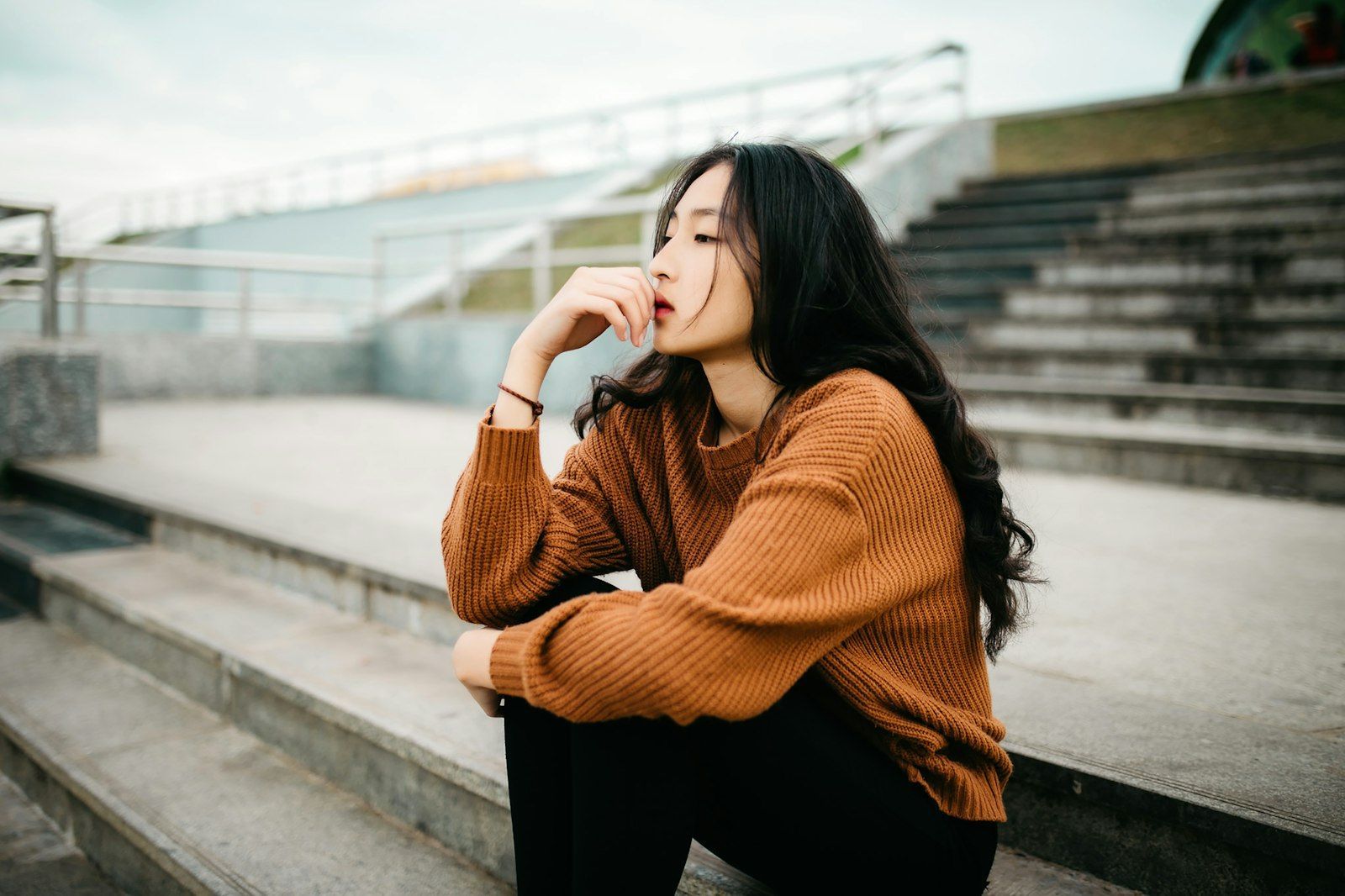 Woman in a brown sweater looking concerned