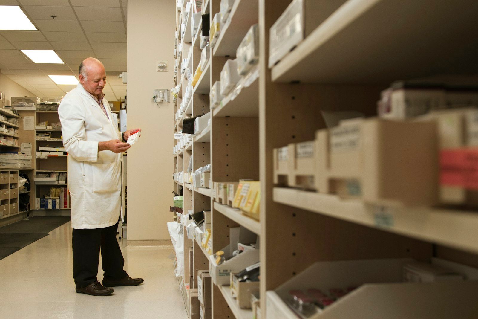 Pharmacist at a pharmacy shelf