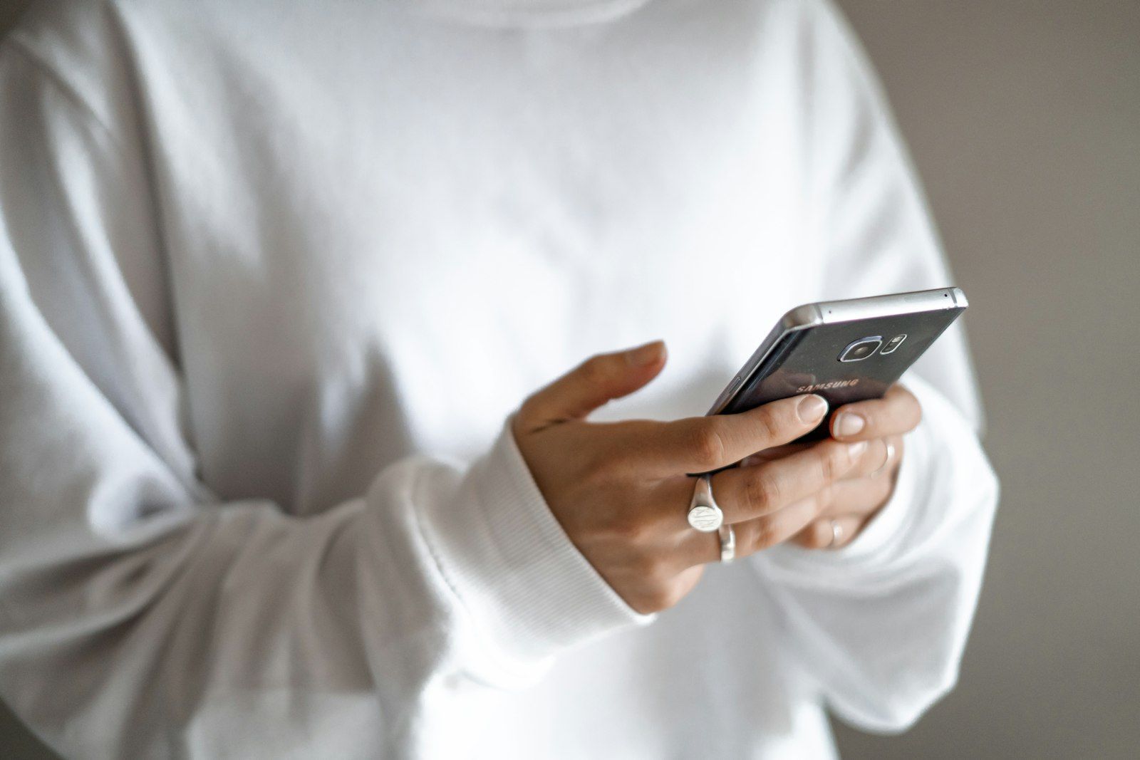 Person holding a smartphone to book an appointment