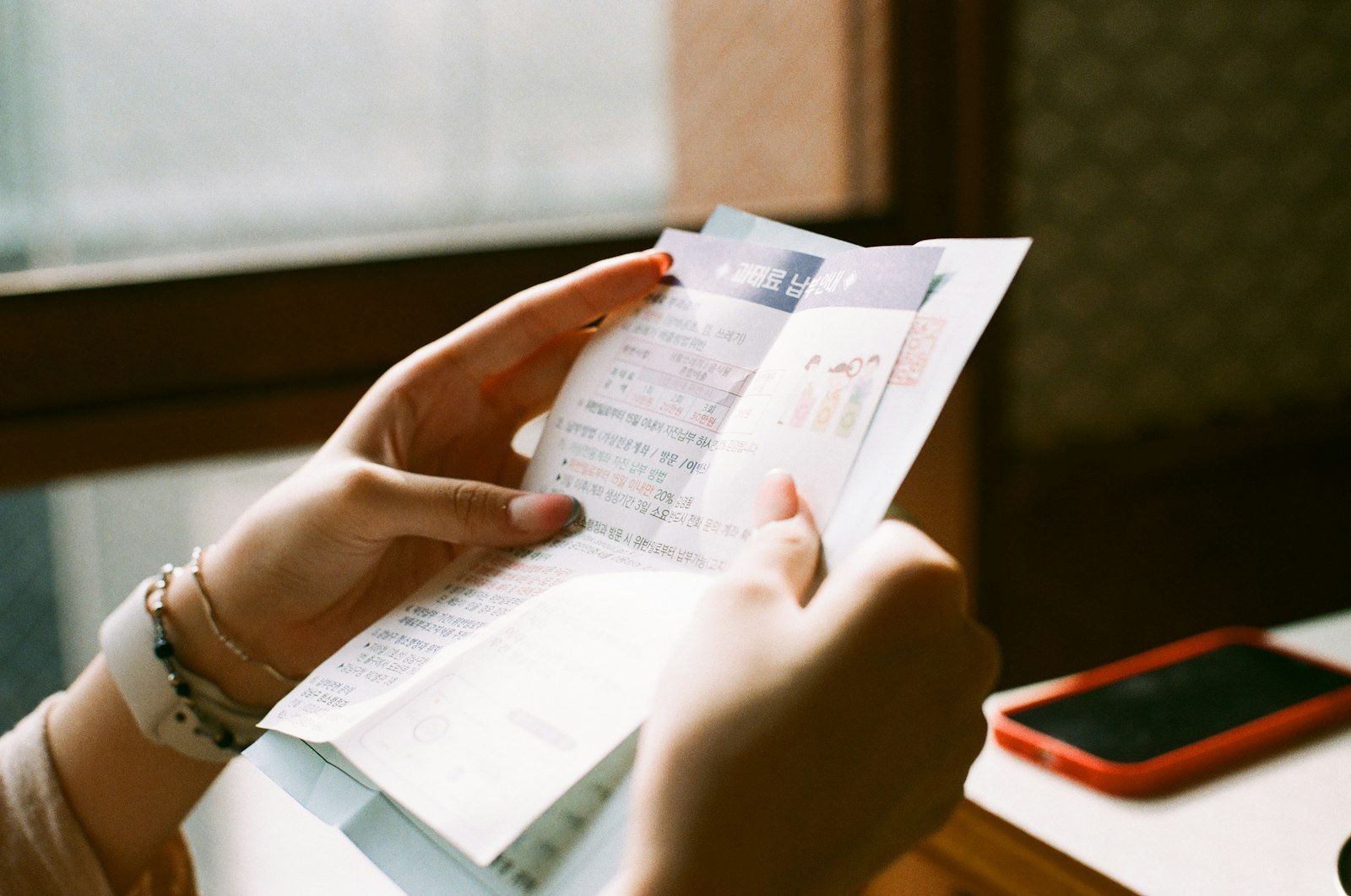 Person holding a printed receipt