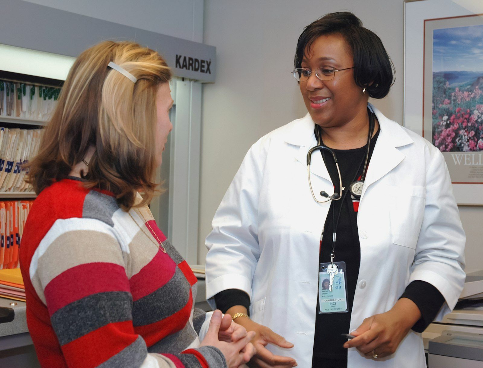 Doctor holding a card during a consultation