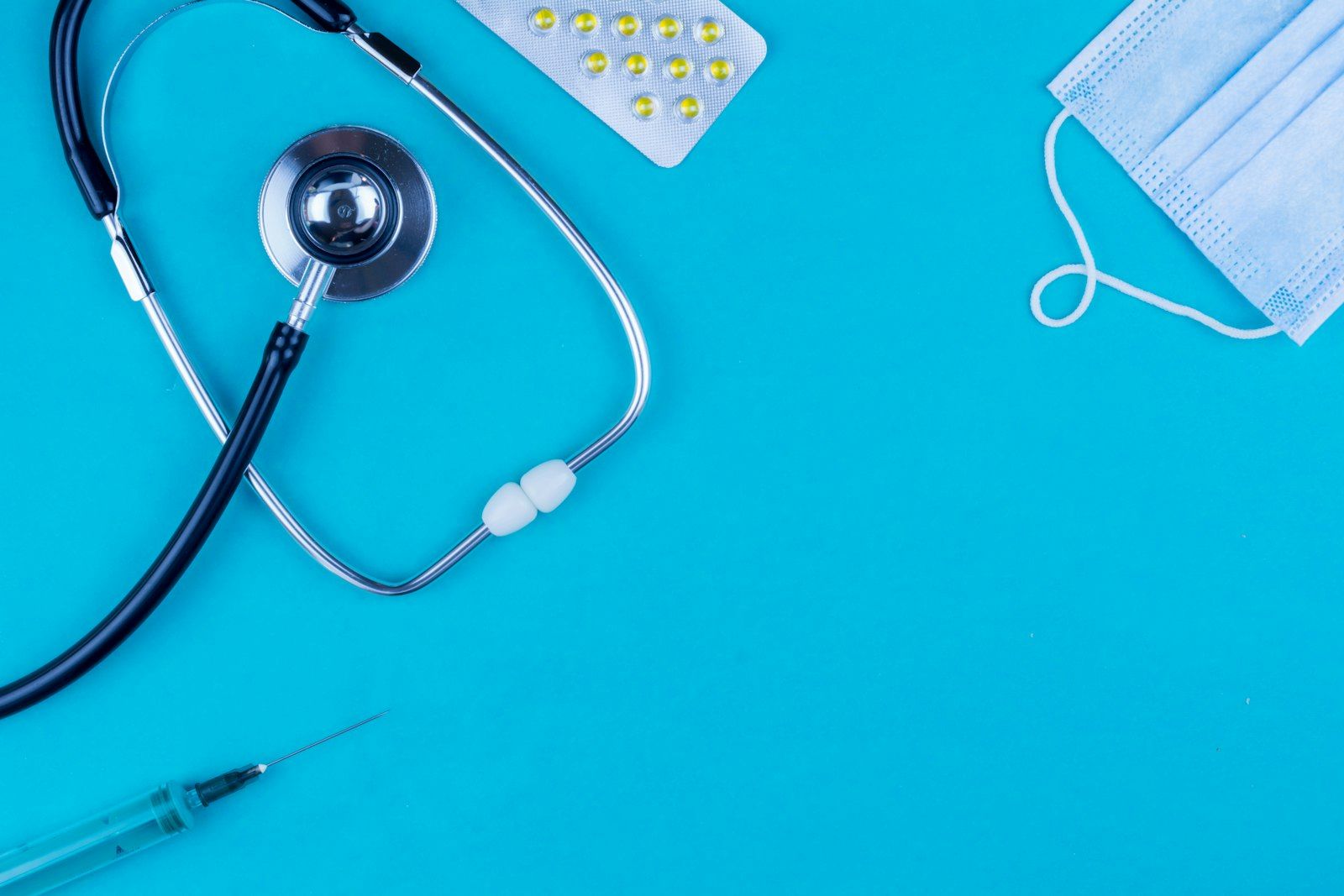 Stethoscope, medical mask and pen