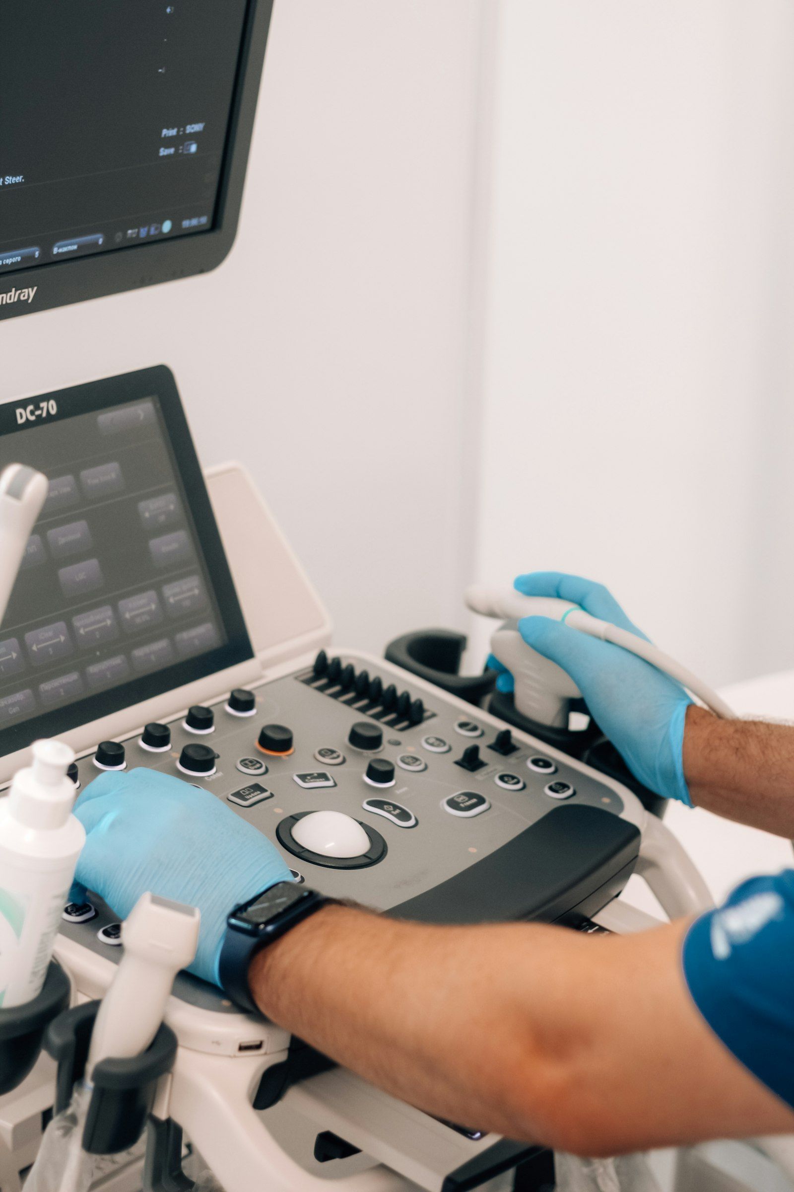 Gloved hands operating medical equipment