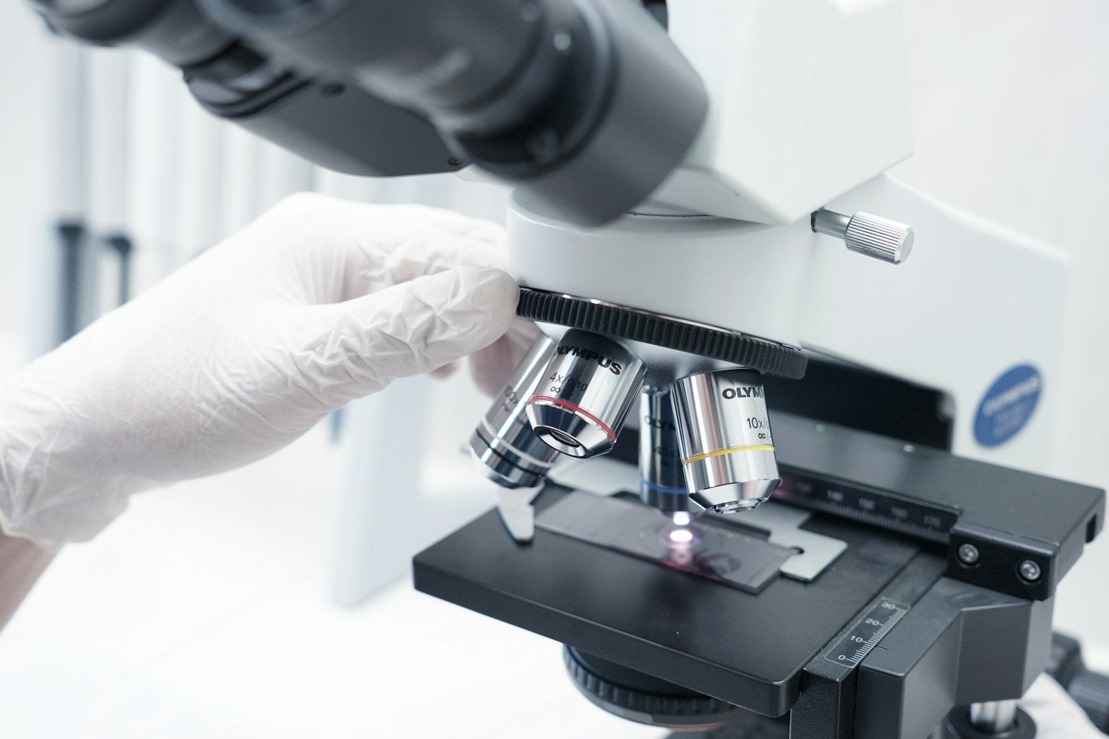 Lab technician looking into a microscope