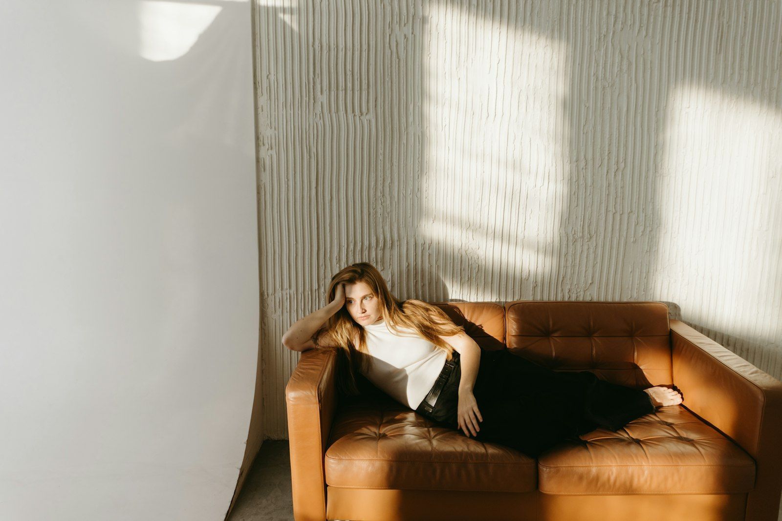 Woman resting on a sofa at home