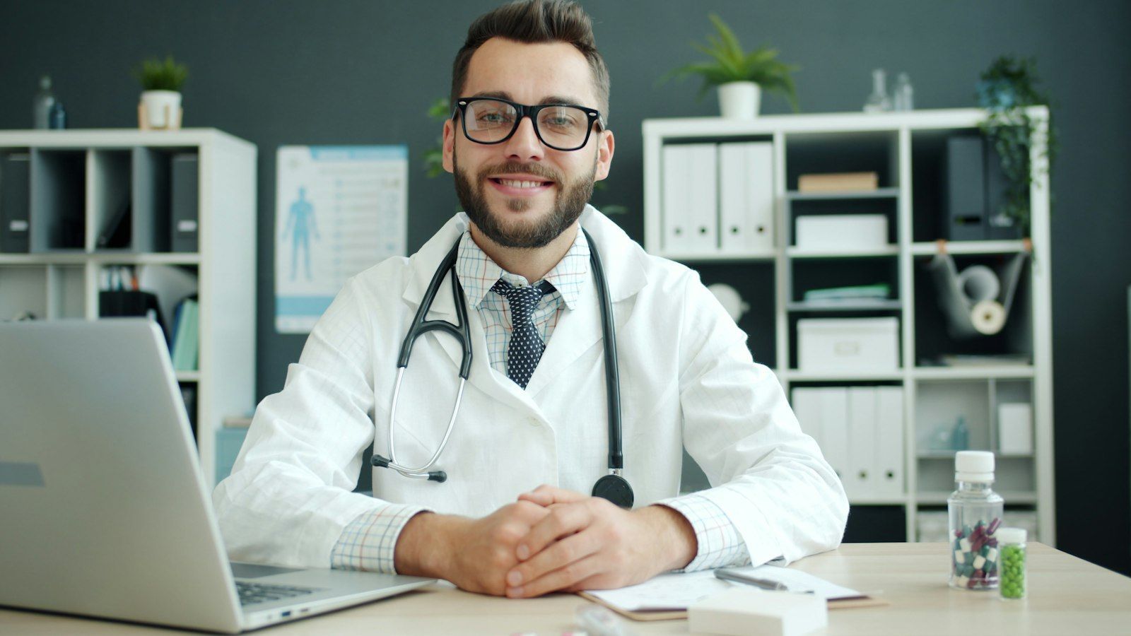Doctor sitting at a desk with a stethoscope