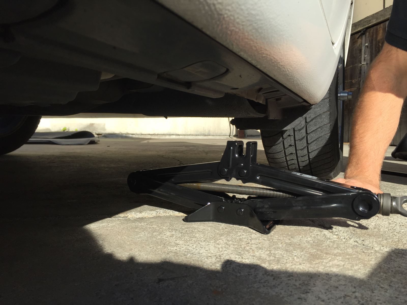 Car jack under a vehicle | A+ Japanese Auto Repair, Inc.
