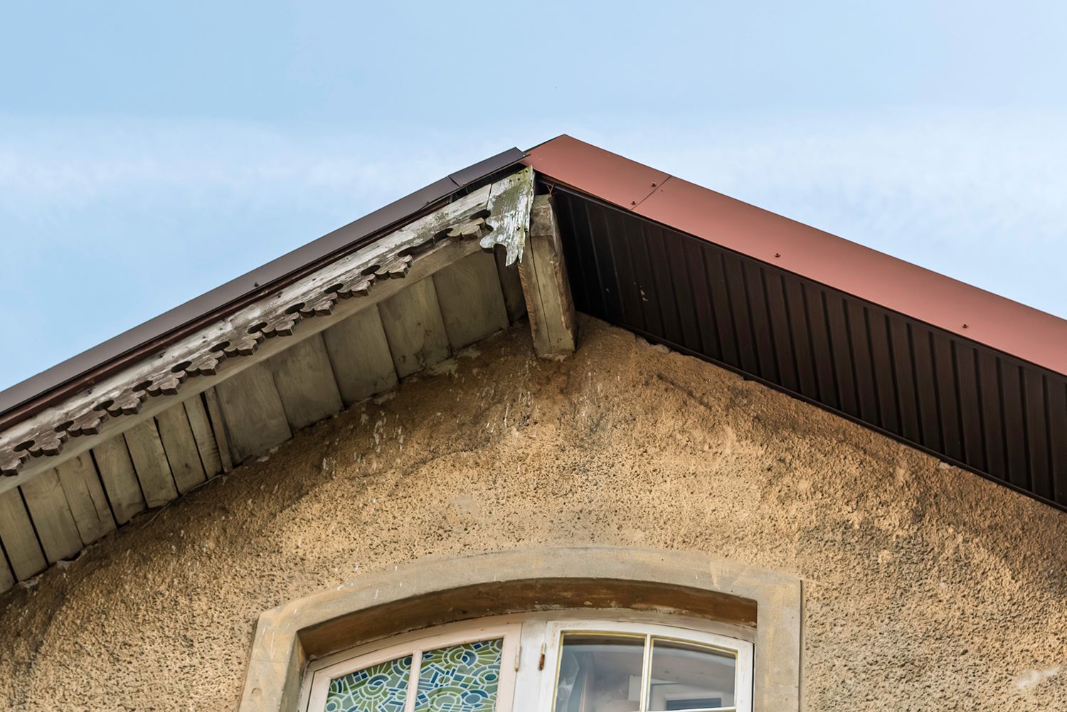 A restoration of an old roof slope with modern metal panels. A restoration of an old roof slope with modern metal panels.